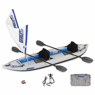 Inflatable tandem kayak with paddles, pump, and carrying bag.