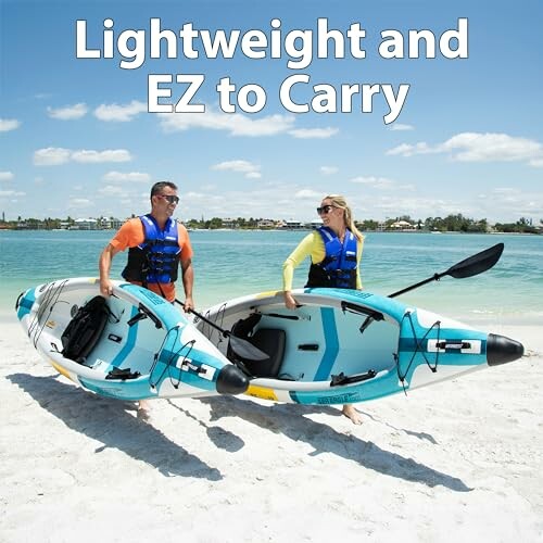 Two people carrying a lightweight kayak on a beach.