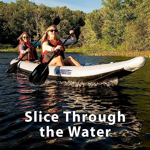 Two people kayaking on a river surrounded by trees.