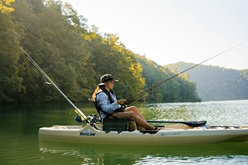 Woman fishing from a kayak on a peaceful lake